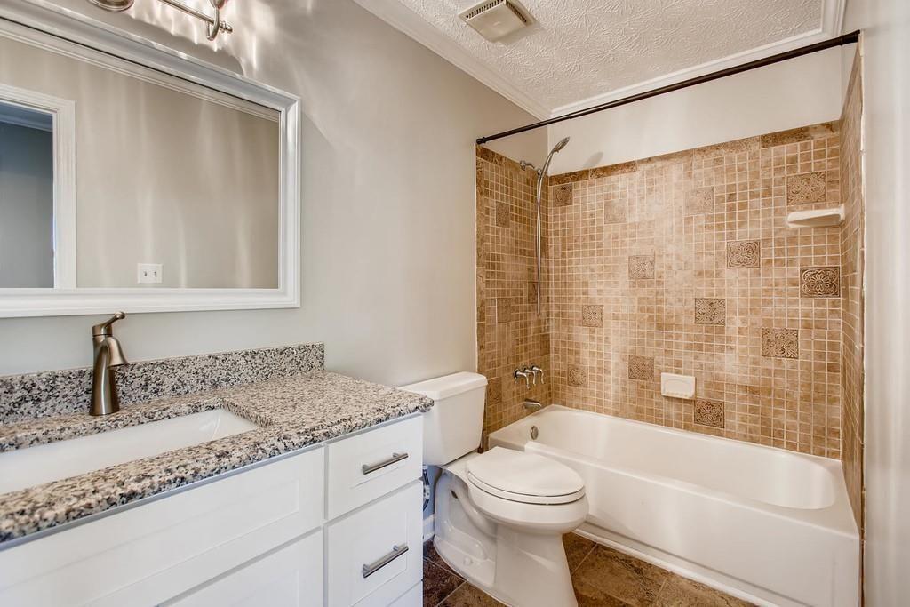 2274 Turtle Landing Marietta, GA 30066 - Photo 18 of 28 a bathroom with a granite countertop sink a toilet and shower