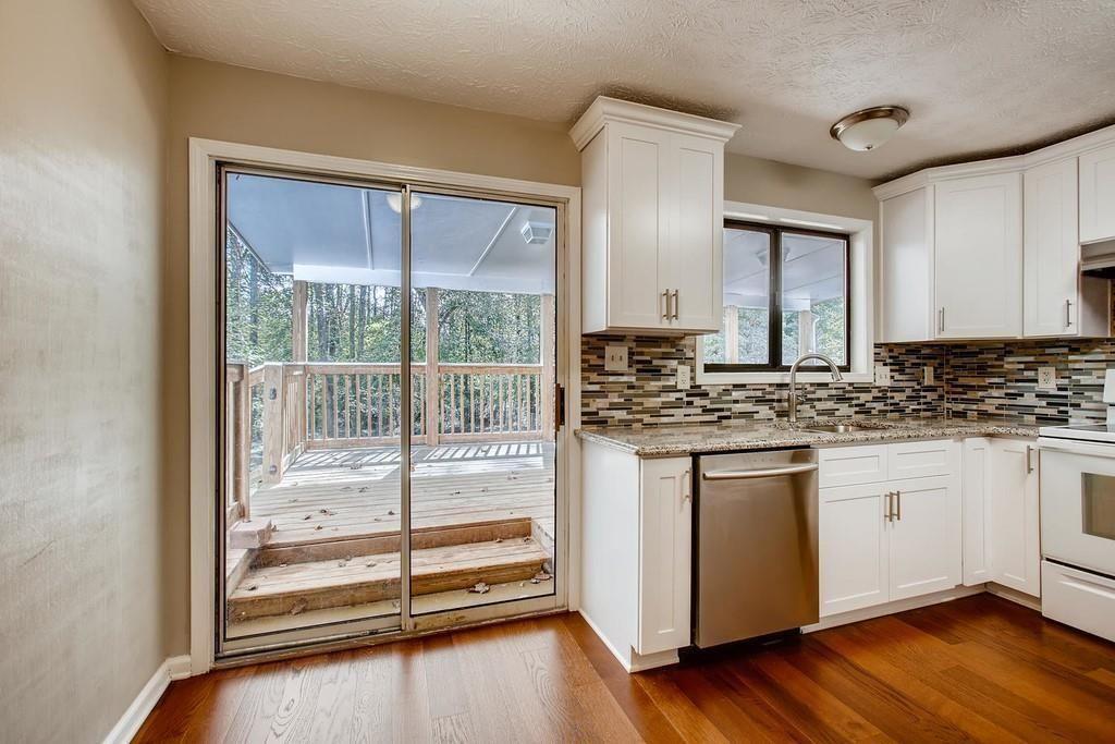2274 Turtle Landing Marietta, GA 30066 - Photo 21 of 28 a kitchen with stainless steel appliances granite countertop a stove and a granite counter tops with wooden floors