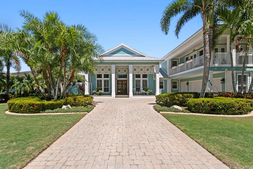 625 Balibay Road Apollo Beach, FL 33572 - Photo 1 of 51 a front view of a house with a yard and potted plants