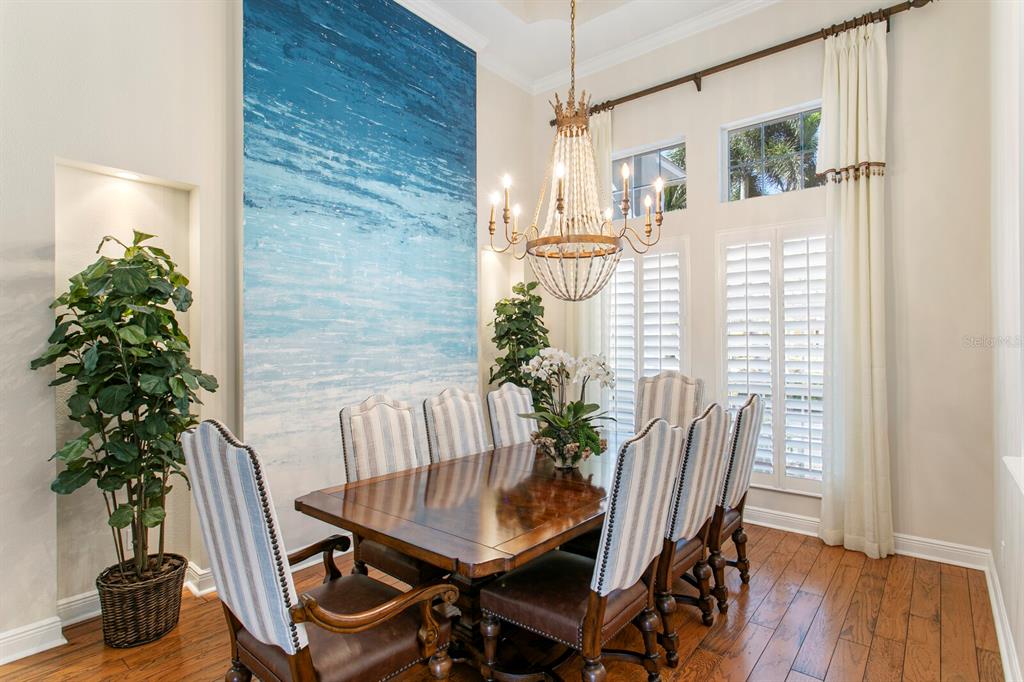 625 Balibay Road Apollo Beach, FL 33572 - Photo 18 of 51 a view of a dining room with furniture and wooden floor