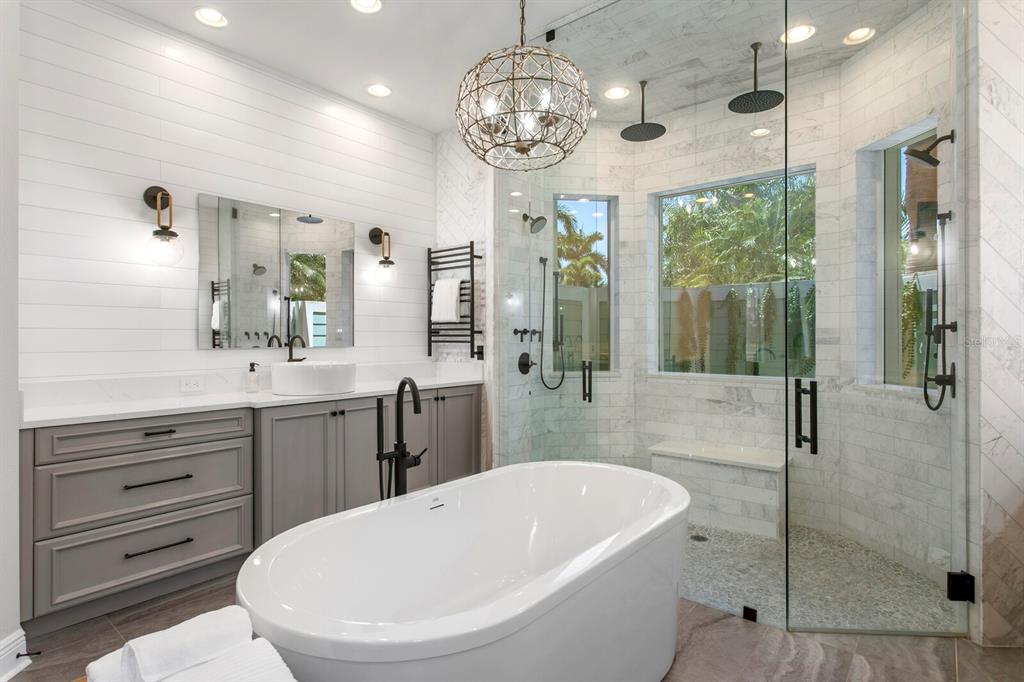 625 Balibay Road Apollo Beach, FL 33572 - Photo 25 of 51 a bathroom with a bathtub a sink and a large mirror