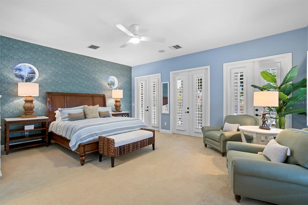 625 Balibay Road Apollo Beach, FL 33572 - Photo 30 of 51 a spacious bedroom with a bed a couch and a chandelier