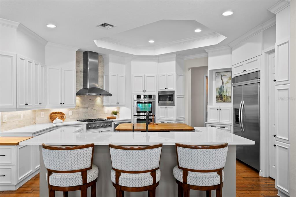 625 Balibay Road Apollo Beach, FL 33572 - Photo 8 of 51 a kitchen with granite countertop a table chairs stove and refrigerator