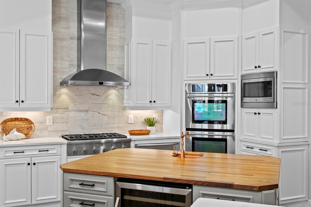 625 Balibay Road Apollo Beach, FL 33572 - Photo 9 of 51 a kitchen with stainless steel appliances a stove microwave and cabinets