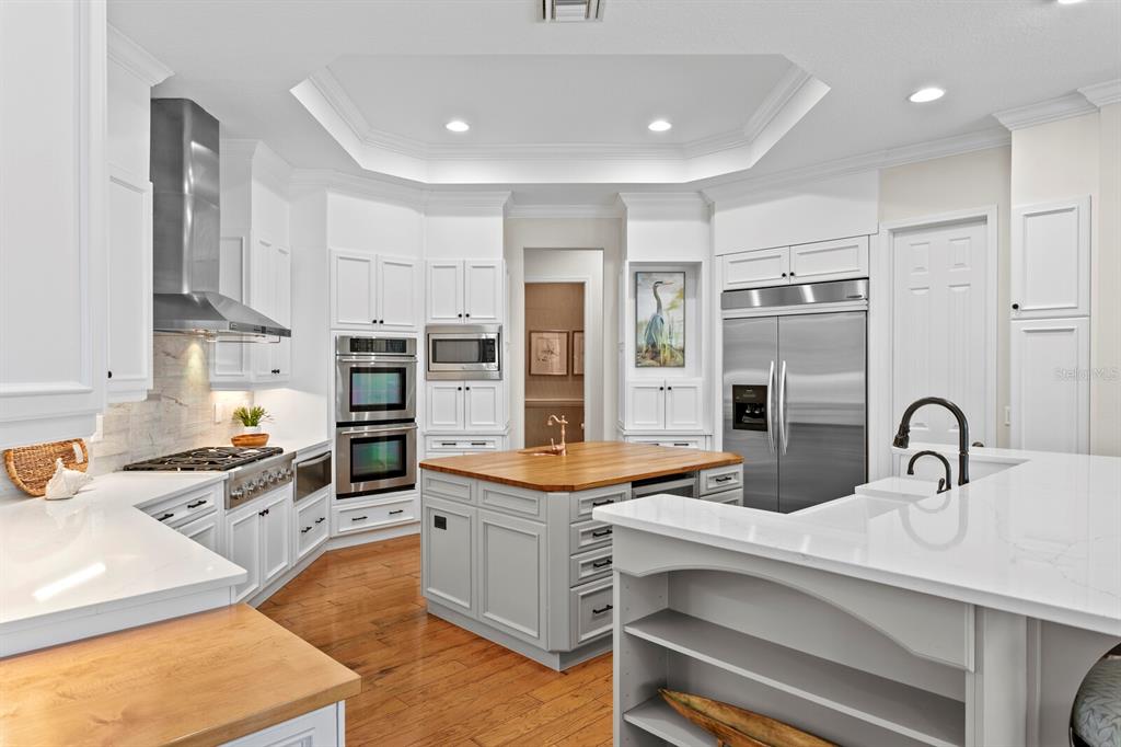 625 Balibay Road Apollo Beach, FL 33572 - Photo 10 of 51 a kitchen with stainless steel appliances kitchen island granite countertop a sink and cabinets