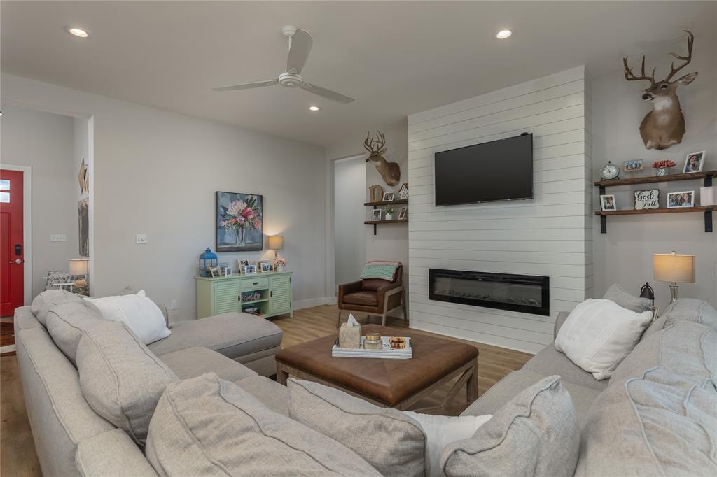 152 Katy Ranch Drive Weatherford, TX 76085 - Photo 11 of 39 Living room with wood finished floors, a fireplace, ceiling fan, and recessed lighting