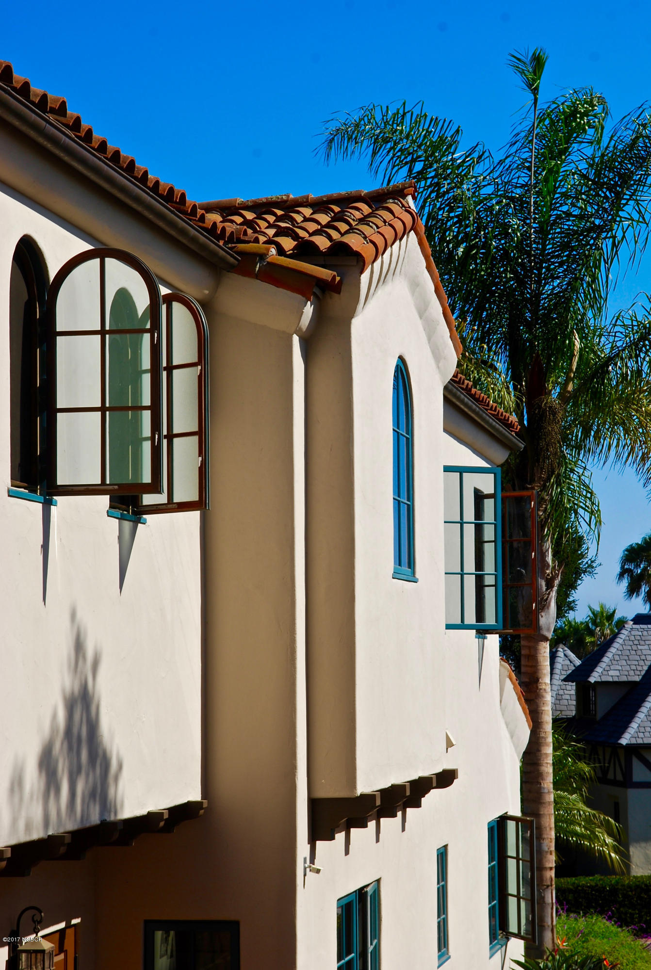 965 Isleta Avenue Santa Barbara, CA 93109 - Photo 14 of 17 a view of a white house with a large windows and flower plants