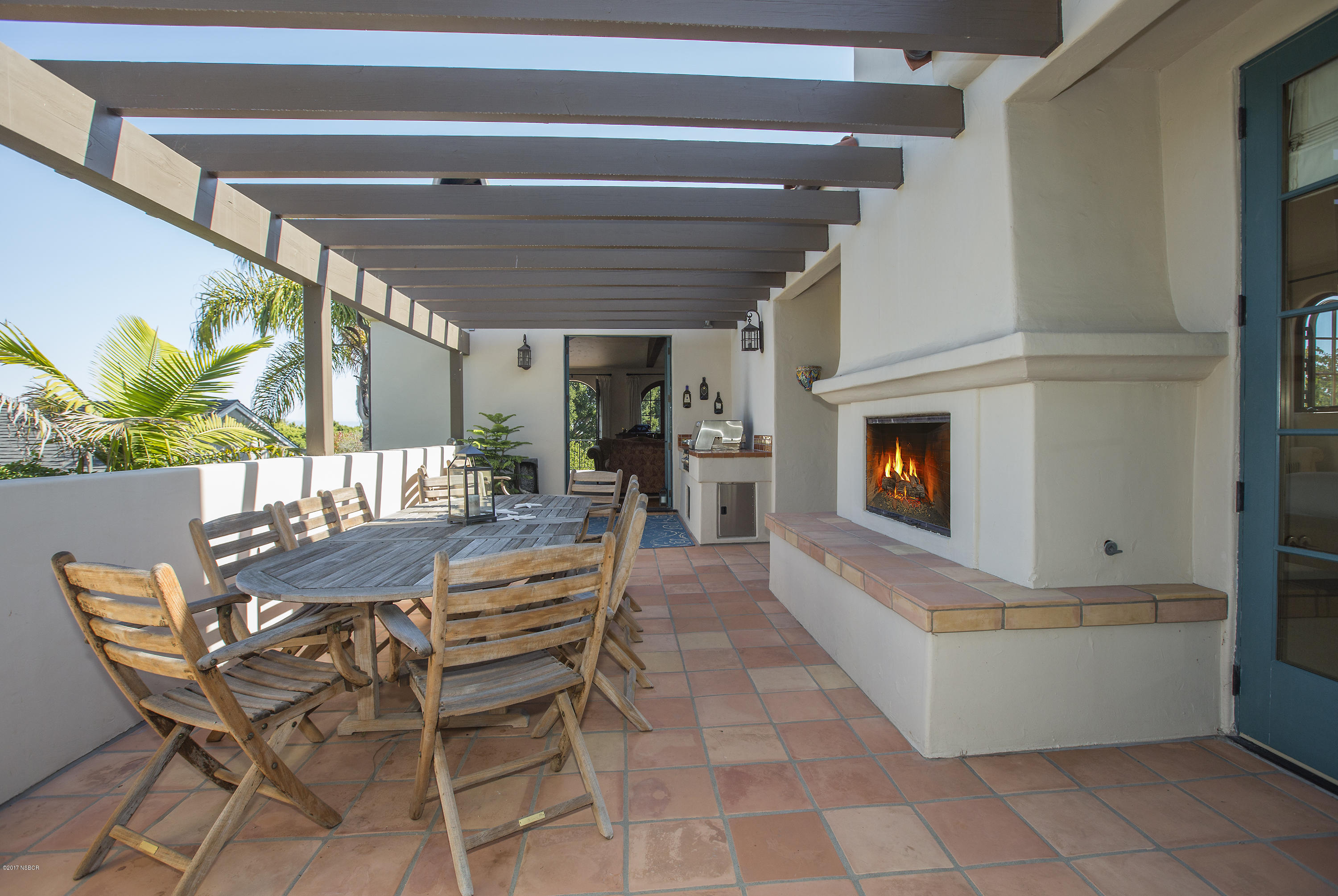 965 Isleta Avenue Santa Barbara, CA 93109 - Photo 7 of 17 a dining room with furniture and a fireplace