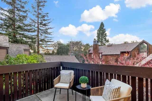 a view of a chairs and a table in the balcony