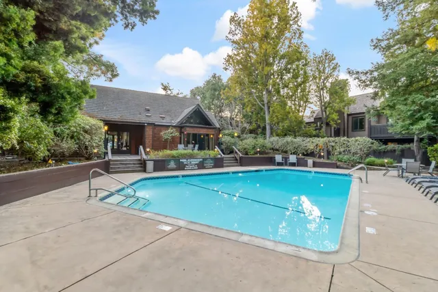 a view of a patio with swimming pool table and chairs