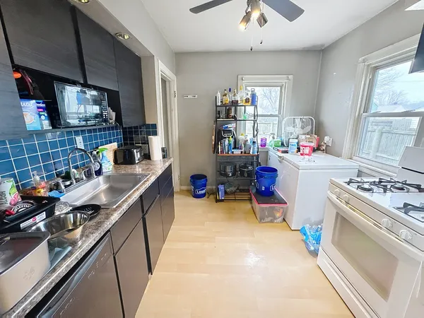 a kitchen filled with stainless steel appliances a stove a sink and a refrigerator