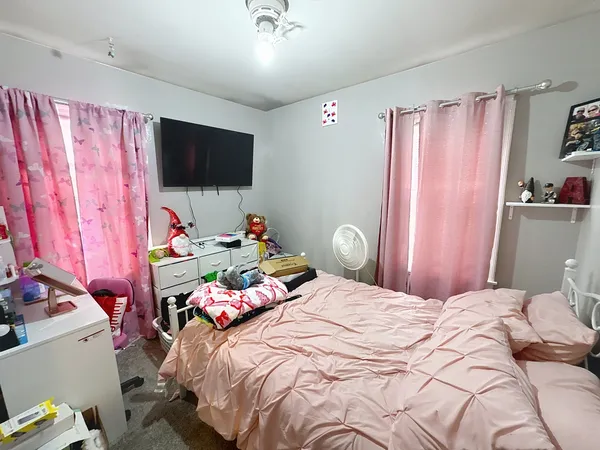 a bedroom with a bed and a flat screen tv