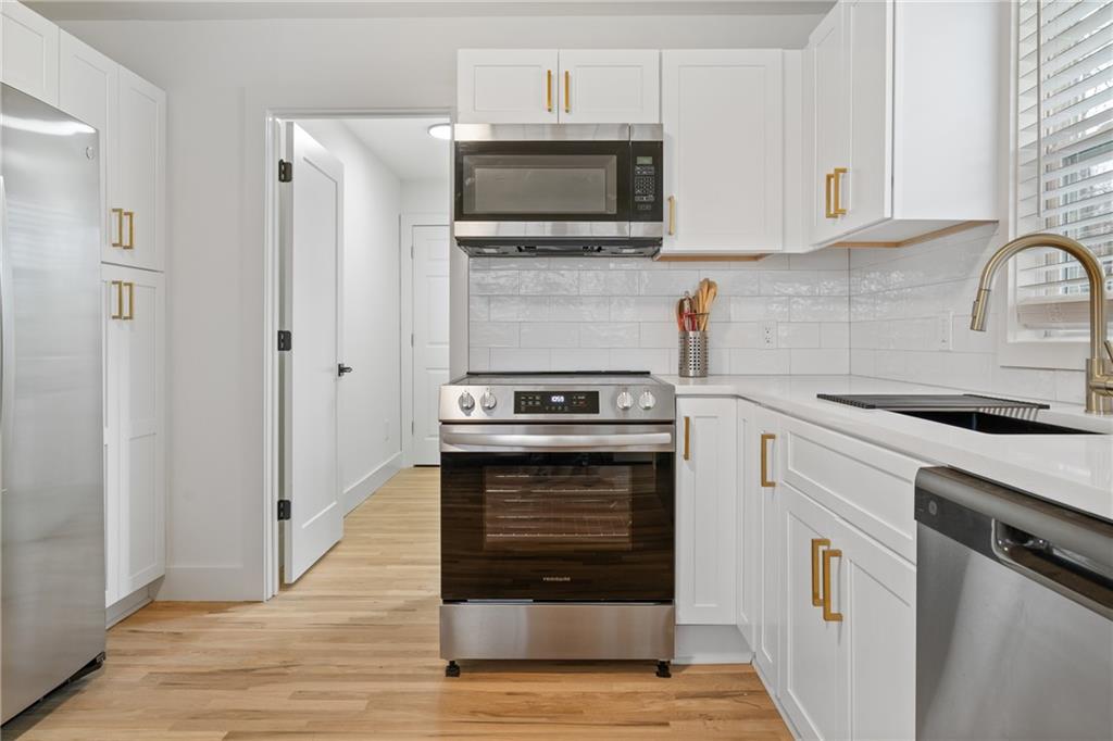 2790 Sardis Street Kennesaw, GA 30144 - Photo 20 of 49 a kitchen with cabinets stainless steel appliances and wooden floor