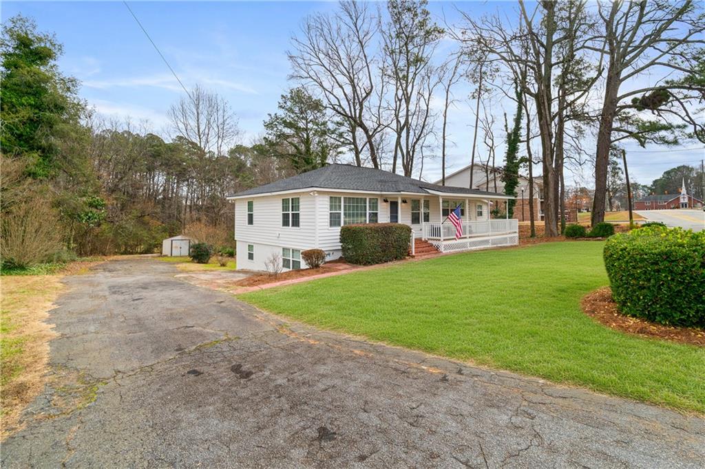2790 Sardis Street Kennesaw, GA 30144 - Photo 2 of 49 a view of a house with a yard and trees