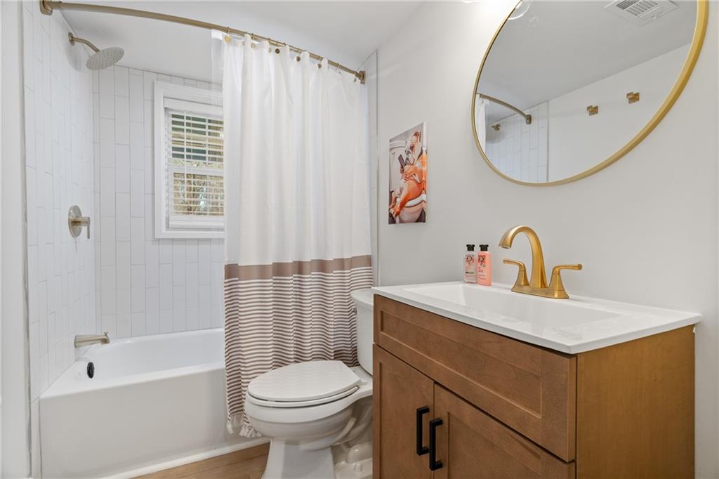 2790 Sardis Street Kennesaw, GA 30144 - Photo 31 of 49 a bathroom with a sink a toilet and a mirror
