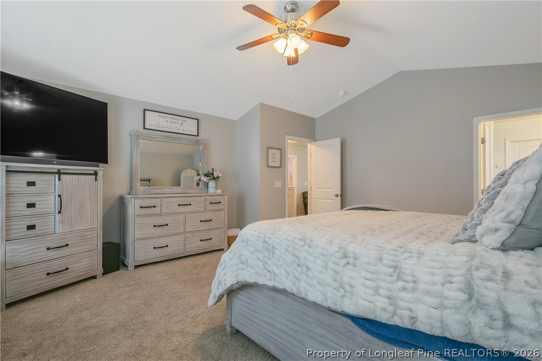 340 Battery Way Bunnlevel, NC 28323 - Photo 25 of 50 a bedroom with a bed and a flat screen tv