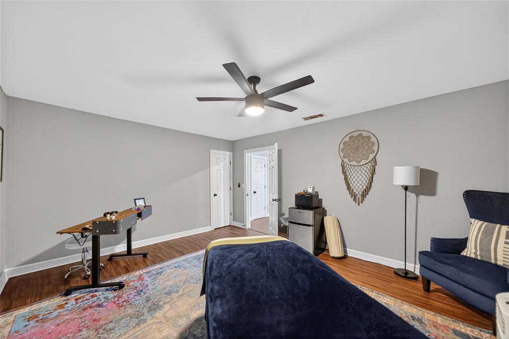 614 Colonial Drive Athens, TX 75751 - Photo 24 of 26 a bed room with a bed and a chandelier