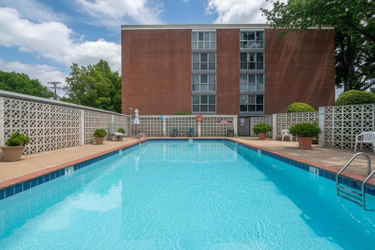 3080 Walnut Grove Road, Unit 306 Memphis, TN 38111 - Photo 17 of 18 Large outdoor swimming pool with a concrete surround, brick coping, and a metal ladder