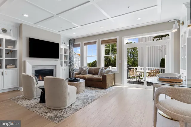 a living room with fireplace furniture and a flat screen tv