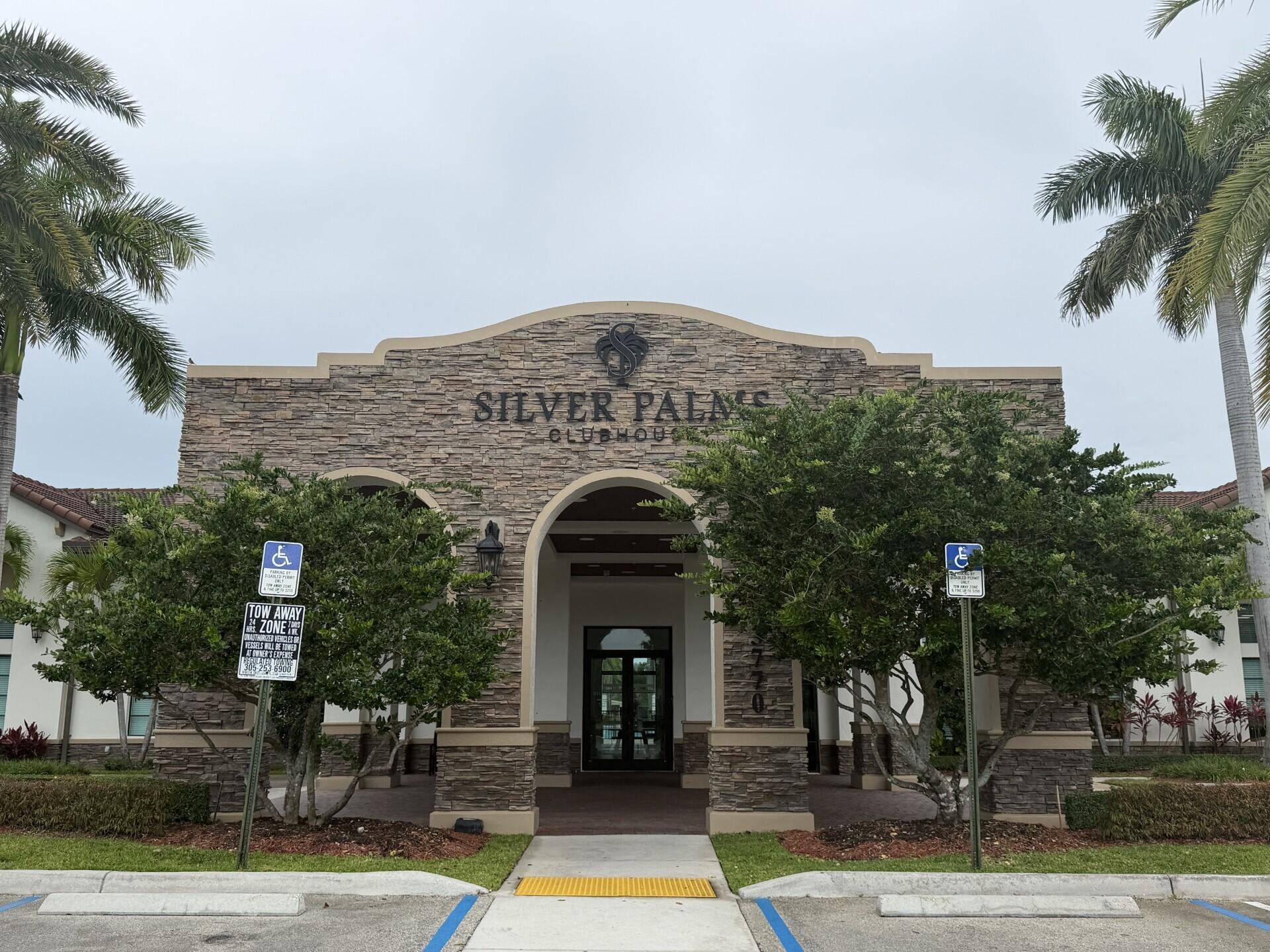 23765 Southwest 118 Avenue, Unit 23765 Homestead, FL 33032 - Photo 27 of 36 front view of a building with a garden
