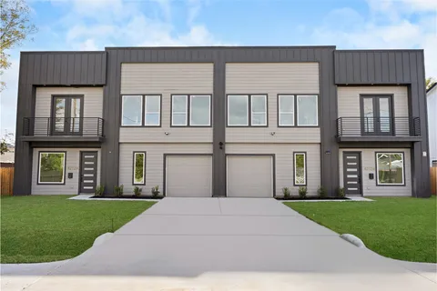 a front view of a brick house with a yard