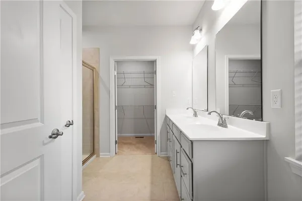a bathroom with a sink and mirror with toilet