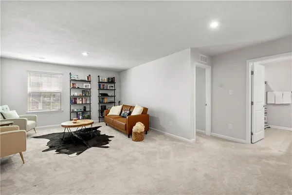 a room with furniture and a book shelf