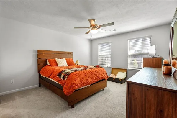a bedroom with a bed and window