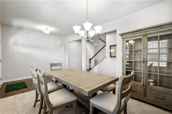 a view of a dining room with furniture large window and wooden floor