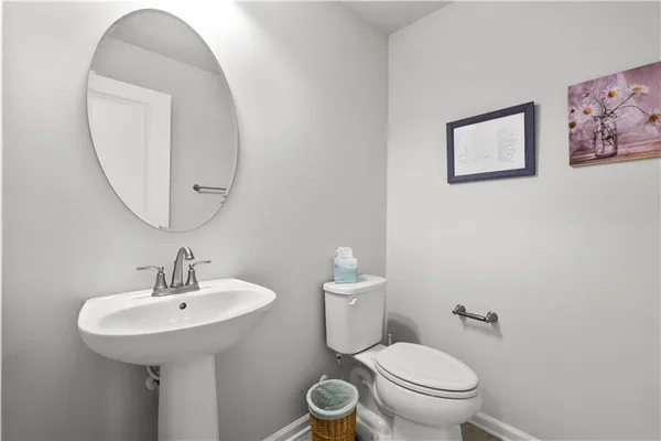 a bathroom with a toilet a sink and a mirror