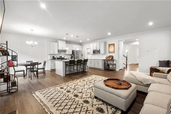 a living room with furniture and kitchen view