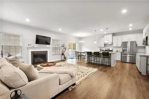 a living room with furniture fireplace and flat screen tv