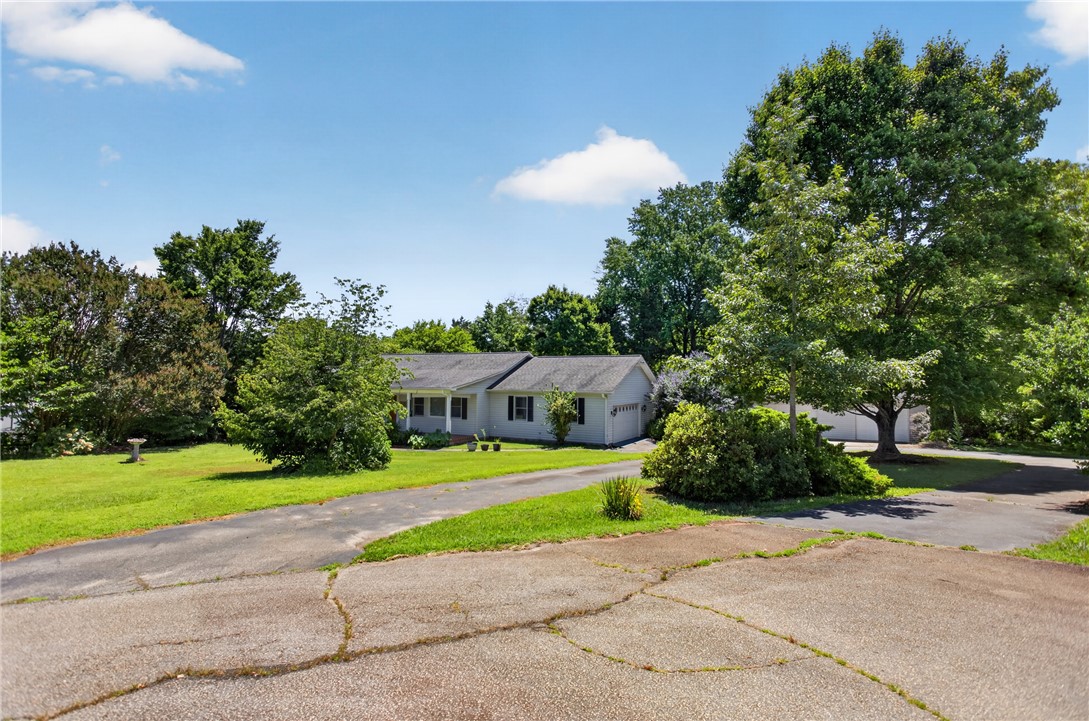 103 Dorsey Lane Walhalla, SC 29691 - Photo 31 of 42 A classic ranch home nestled among mature trees offers serene country living with a welcoming porch.
