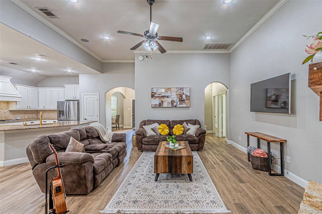 1805 Stetson Way Allen, TX 75002 - Photo 5 of 22 Spacious open-concept living area featuring wood-finish flooring, vaulted ceilings, and recessed lighting