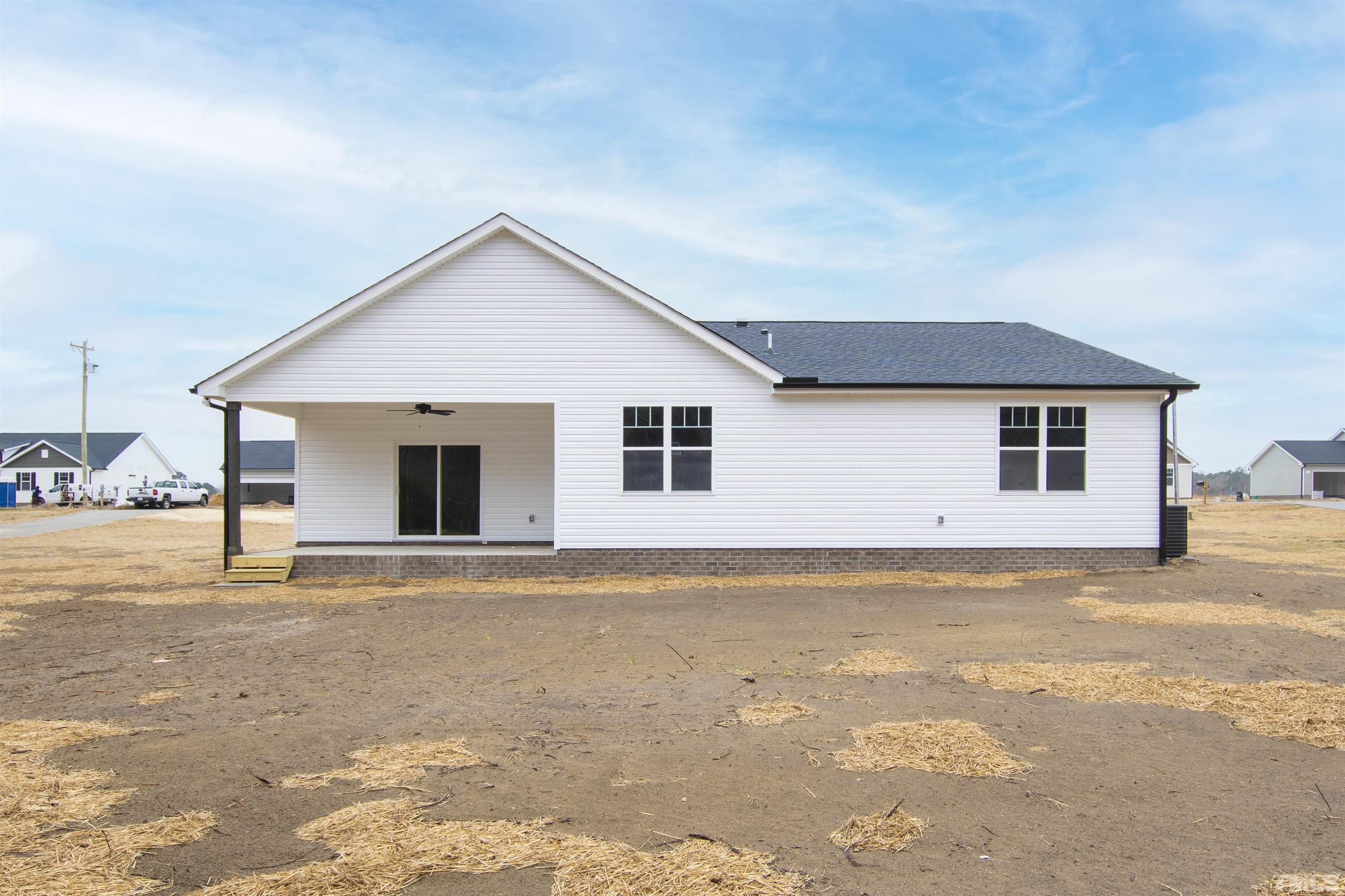 9677 Chapman Road Bailey, NC 27807 - Photo 14 of 31 a view of a house with a yard and garage