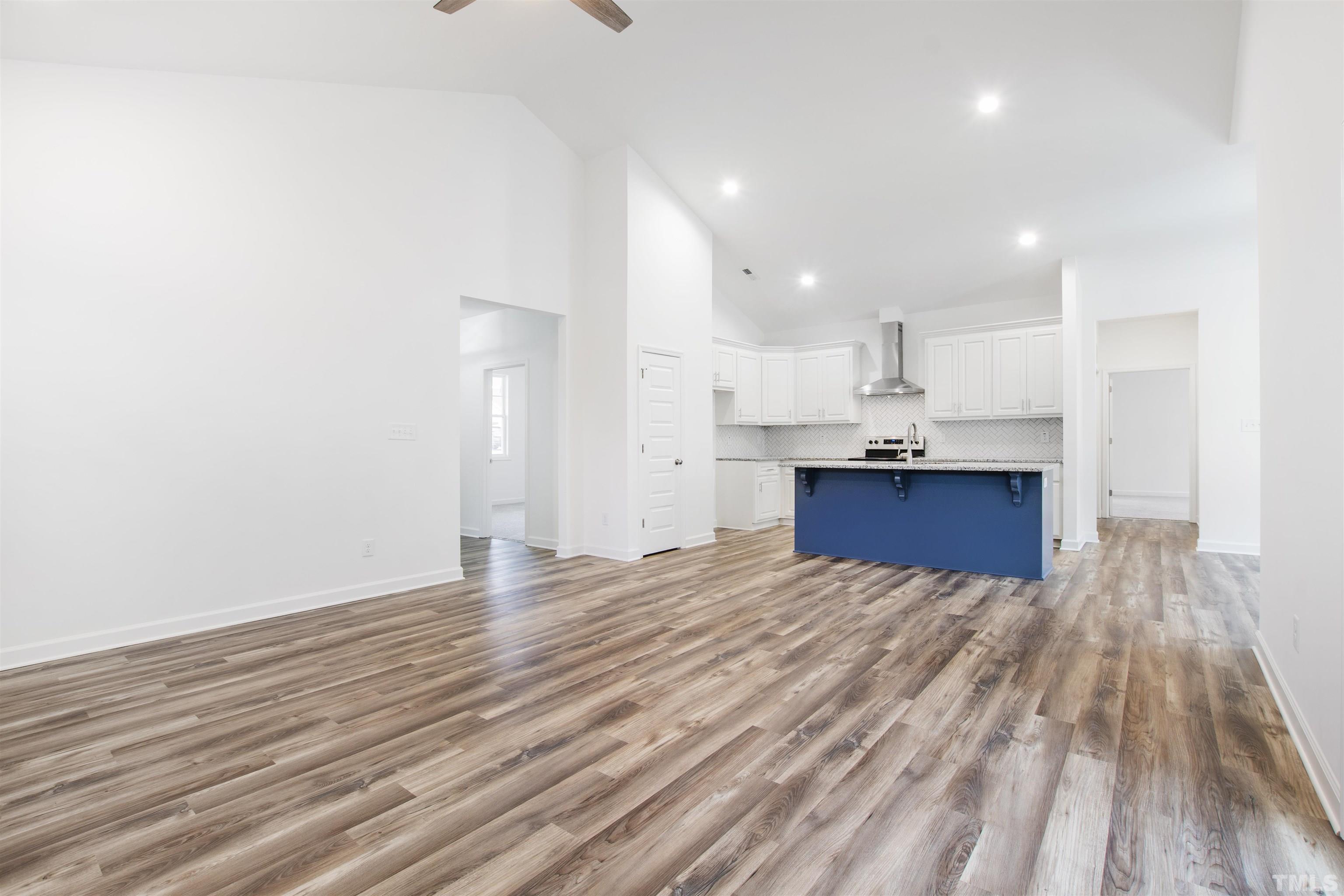 9677 Chapman Road Bailey, NC 27807 - Photo 16 of 31 a view of kitchen and empty room with wooden floor