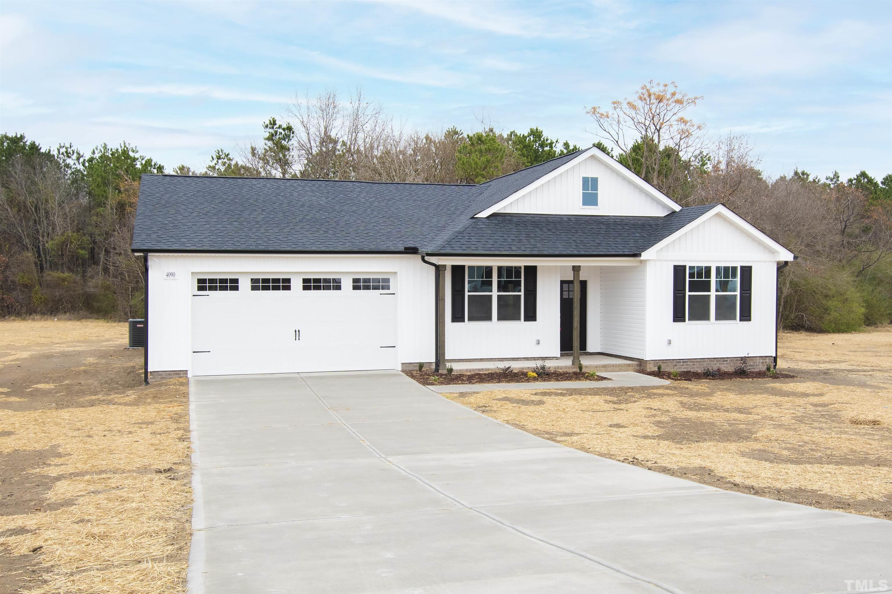 9677 Chapman Road Bailey, NC 27807 - Photo 7 of 31 a view of a white house with a yard and plants