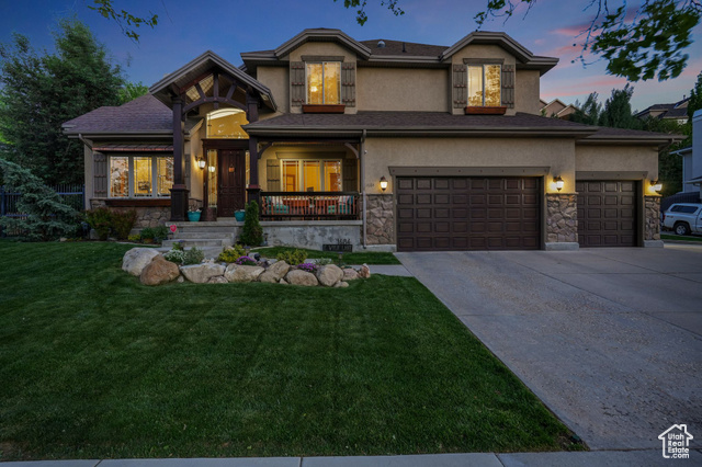 1684 Wylie Lane Draper, UT 84020 - Photo 1 of 1 View of front of property featuring stone siding, a front lawn, concrete driveway, and stucco siding