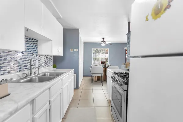 a kitchen with a sink and a refrigerator
