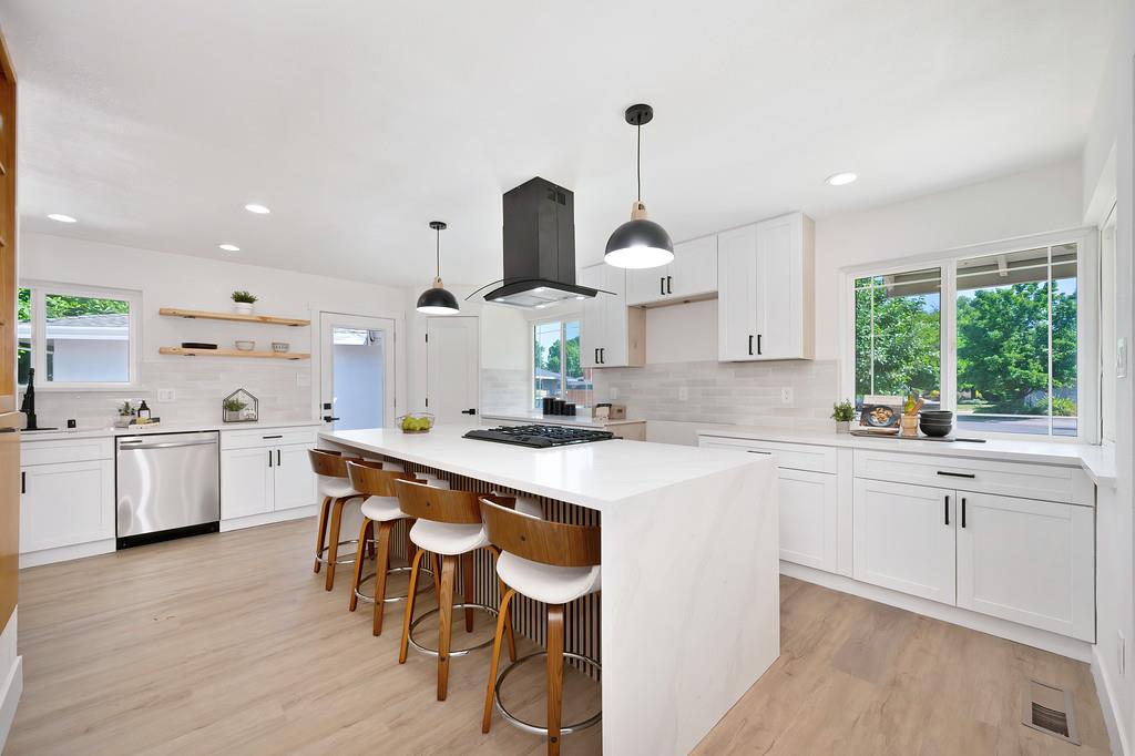 4824 Cory Court Carmichael, CA 95608 - Photo 1 of 1 a kitchen with stainless steel appliances a table chairs sink and stove top oven