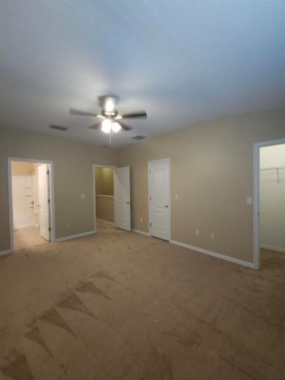 15662 Stable Run Drive Spring Hill, FL 34610 - Photo 19 of 29 a view of an empty room with a chandelier fan