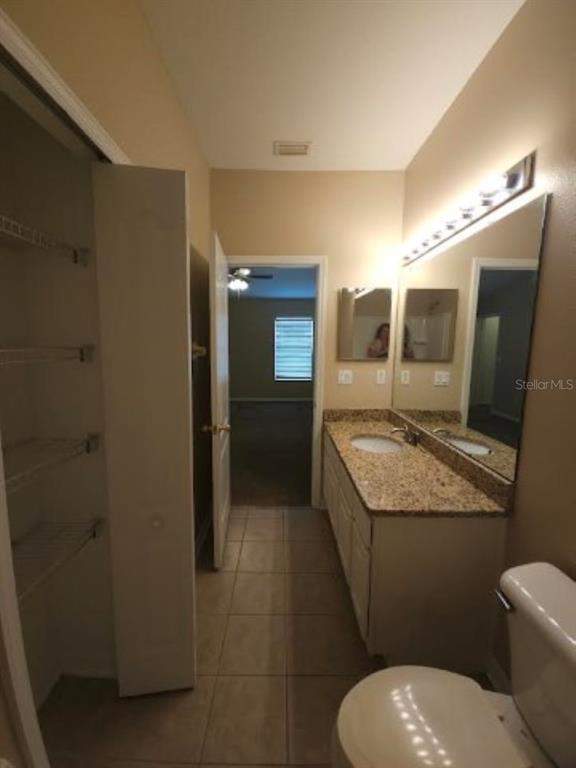 15662 Stable Run Drive Spring Hill, FL 34610 - Photo 21 of 29 a bathroom with a granite countertop toilet sink and mirror