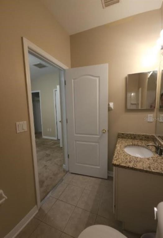 15662 Stable Run Drive Spring Hill, FL 34610 - Photo 25 of 29 a bathroom with a granite countertop sink and a mirror