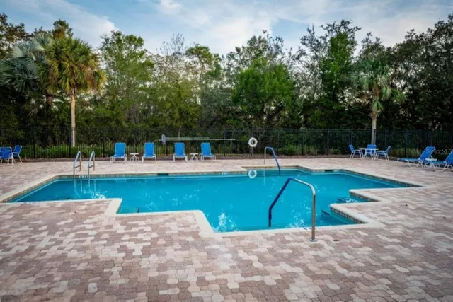 a view of a swimming pool with a patio