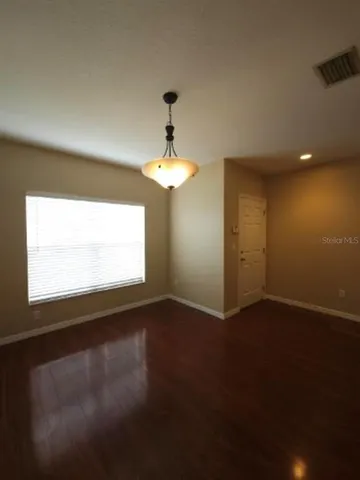 a kitchen with a refrigerator and a granite counter top
