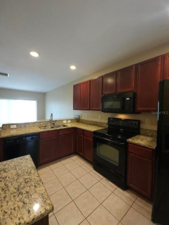 15662 Stable Run Drive Spring Hill, FL 34610 - Photo 7 of 29 a kitchen with stainless steel appliances granite countertop a stove a sink and a microwave
