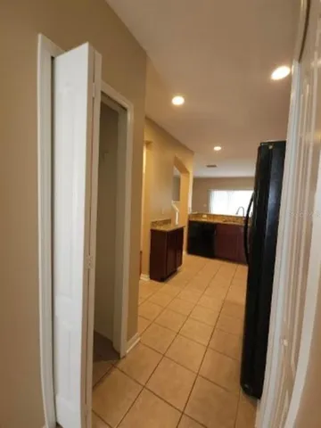 a kitchen with stainless steel appliances kitchen island granite countertop a refrigerator and a sink