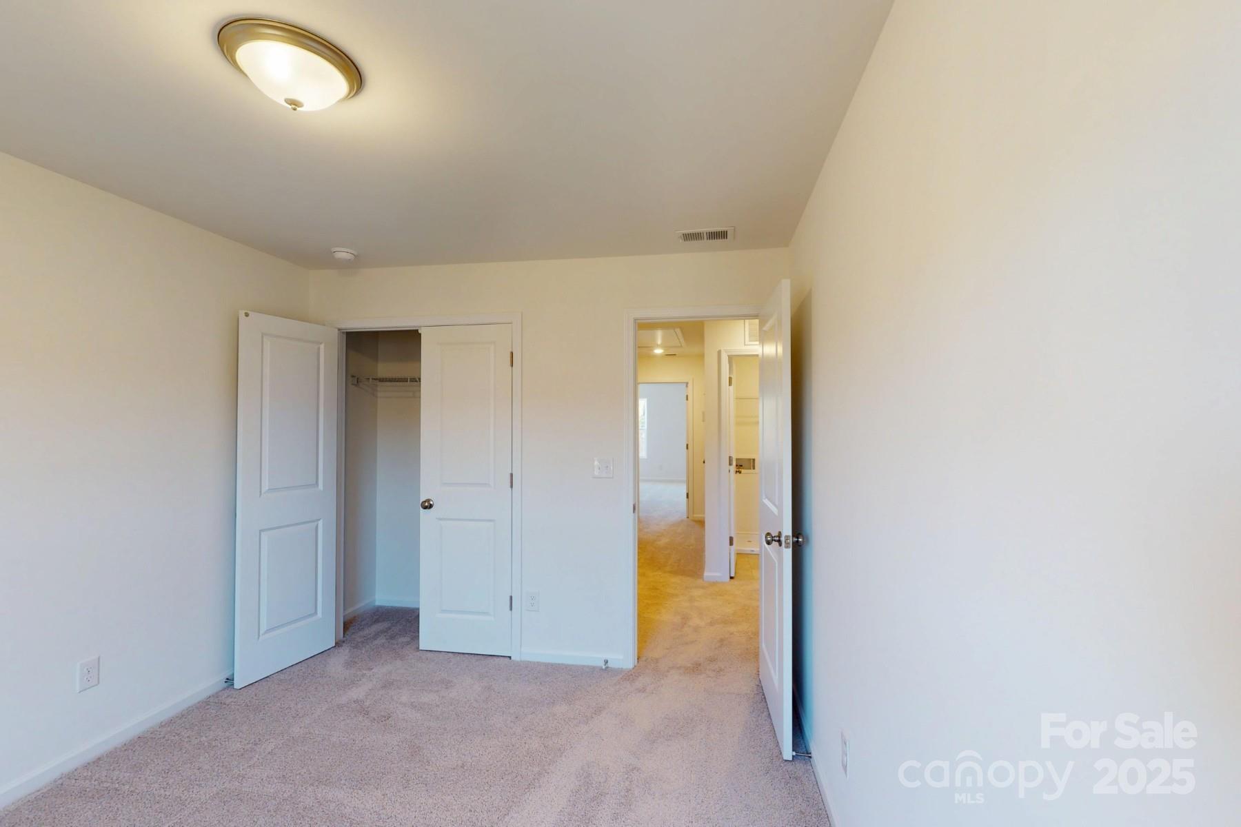 1137 Overbrook Place Wingate, NC 28174 - Photo 13 of 16 an empty room with mirror in it
