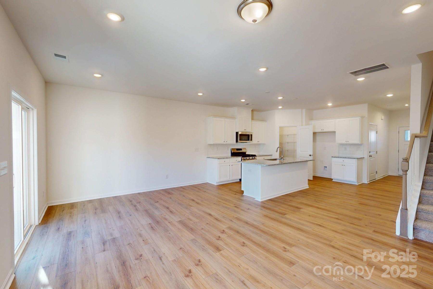 1137 Overbrook Place Wingate, NC 28174 - Photo 10 of 16 a view of kitchen with kitchen island wooden floor and stainless steel appliances