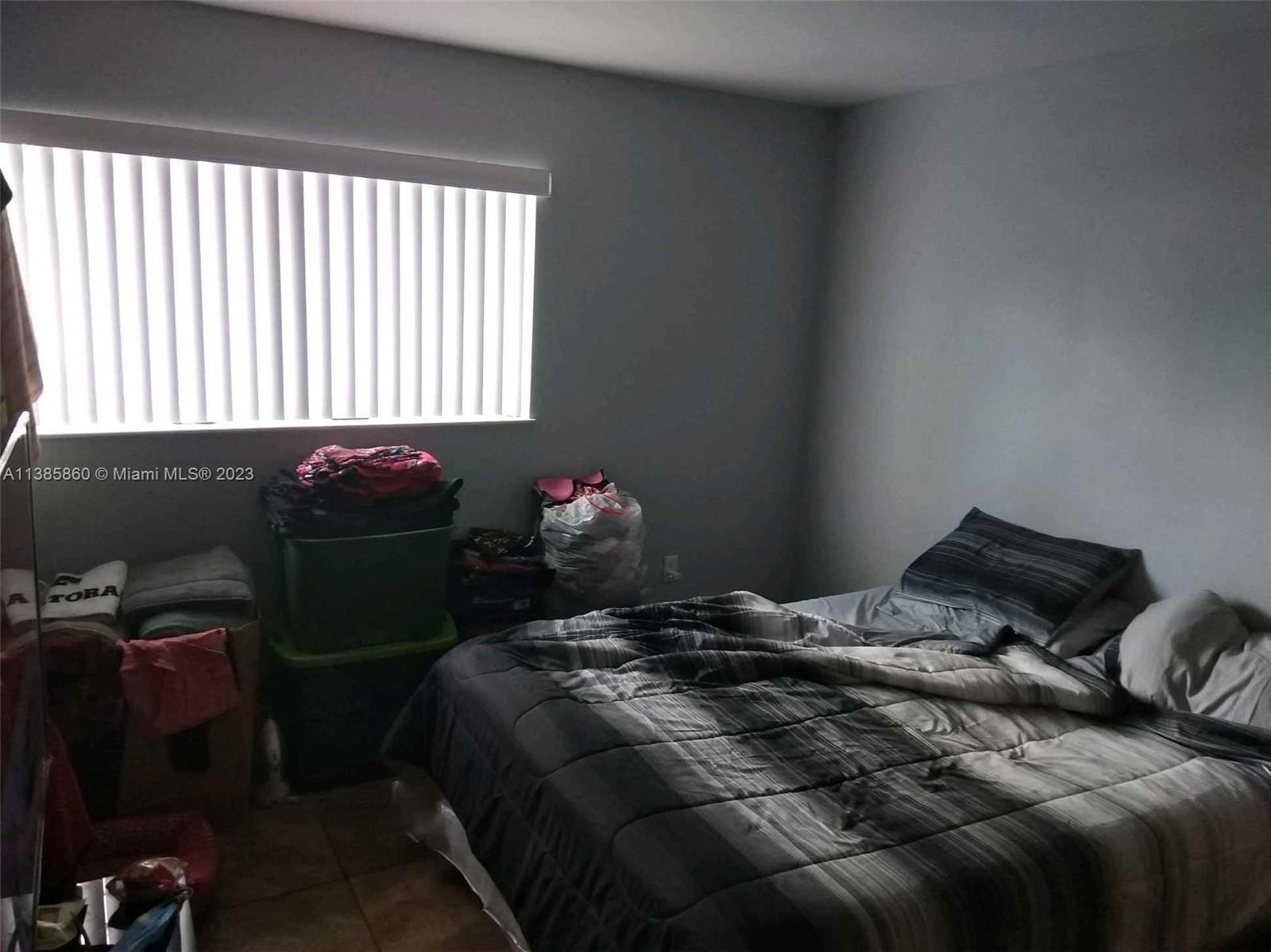 1968 Northwest 4th Court, Unit 323 Miami, FL 33136 - Photo 11 of 12 a bedroom with a bed and a window